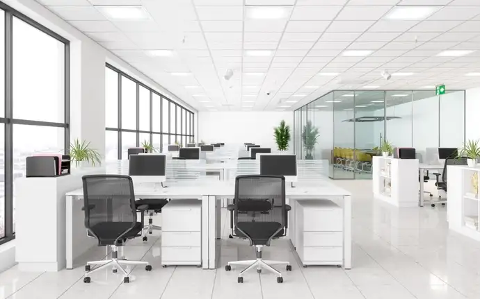 Interior of an office, with glass partitions and desk dividers
