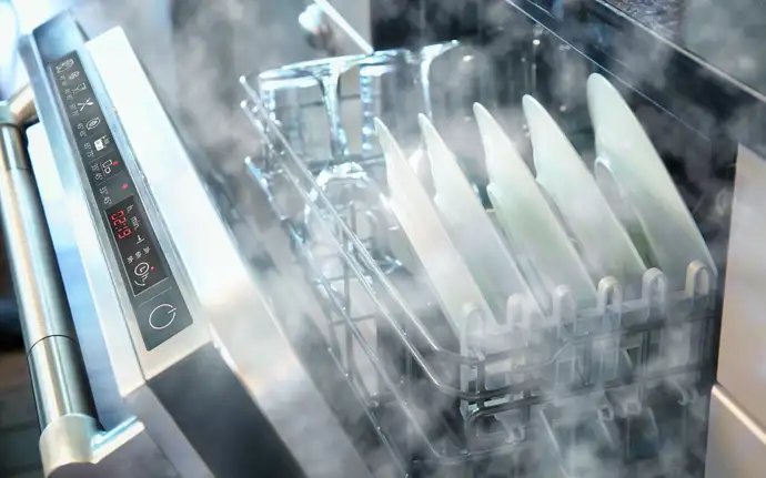 An open dishwasher releases steam after a completed wash cycle. The glass control panel is good visible thru a coating.