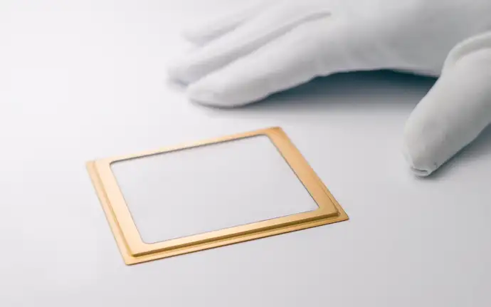 One miniaturized optical MEMS lids next to a hand