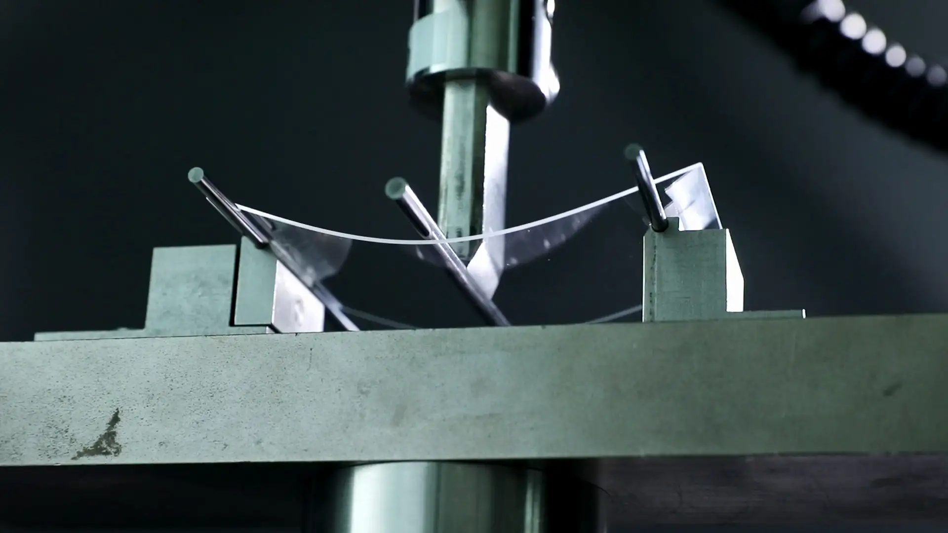 A glass testing machine and a cover glass sample.