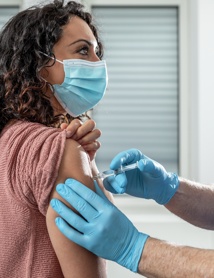 Woman receives vaccination from syriQ syringe