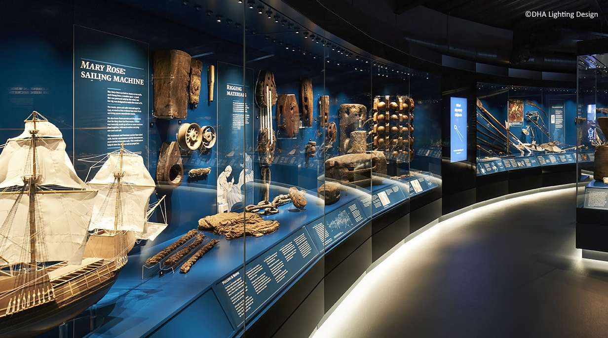 Series of showcases in a museum with boat model and maritime artifacts 