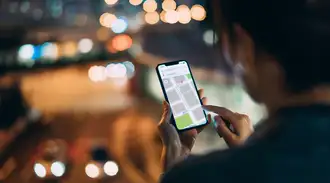 Person using a smartphone navigation app in a city environment