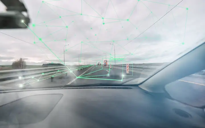 Automotive sensing system detecting surroundings through windshield with sensor-based perception overlays
