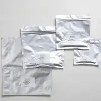 Packaging pouches in different sizes arranged on a neutral background