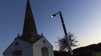 A solar-powered street light with blue sky background