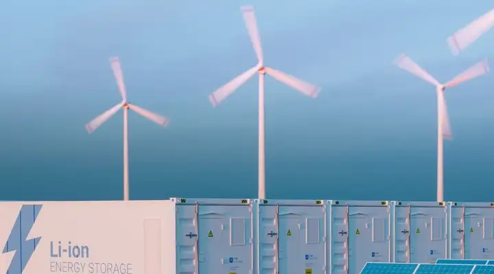 Series of large Li-Ion batteries underneath five wind turbines