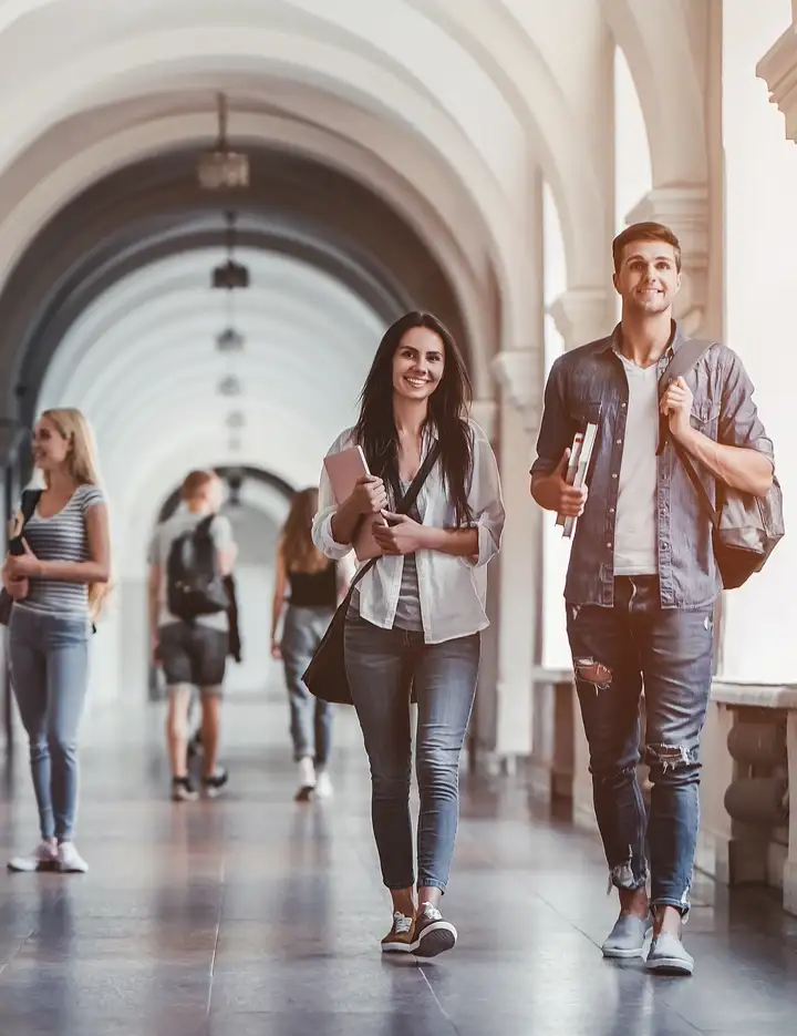 Young people walking down the hallway of a university building