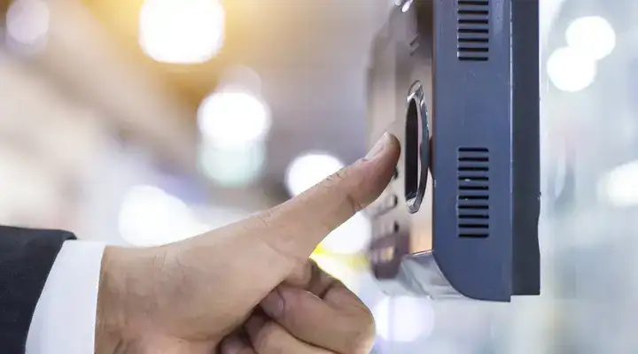 Thumb poised over a fingerprint touchscreen security system