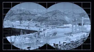 View of an industrial factory through night vision goggles appearing in an off-white color