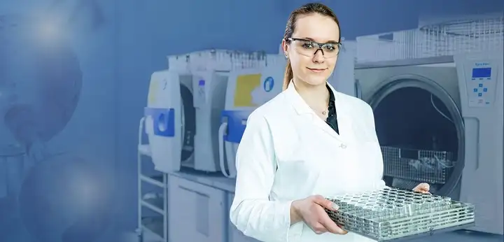 Female laboratory technician holding tray of pharmaceutical containers