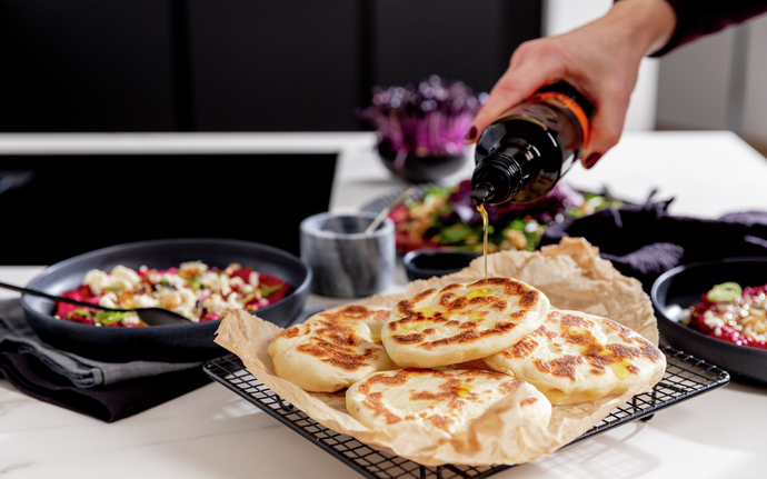 Naan bread is garnished with oil