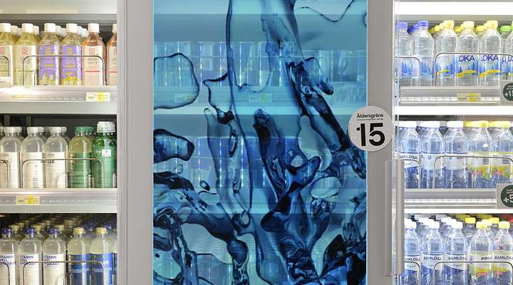 SCHOTT Termofrost® Ad Door system in a row of clear commercial refrigerator doors