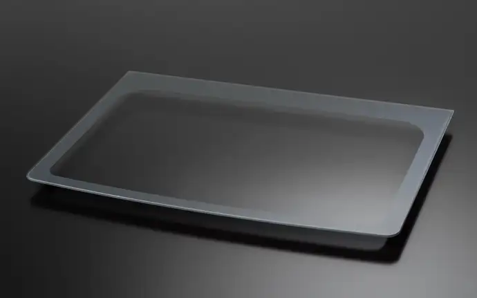 Curved rectangular glass panel for a washing machine, displayed on a dark reflective surface.