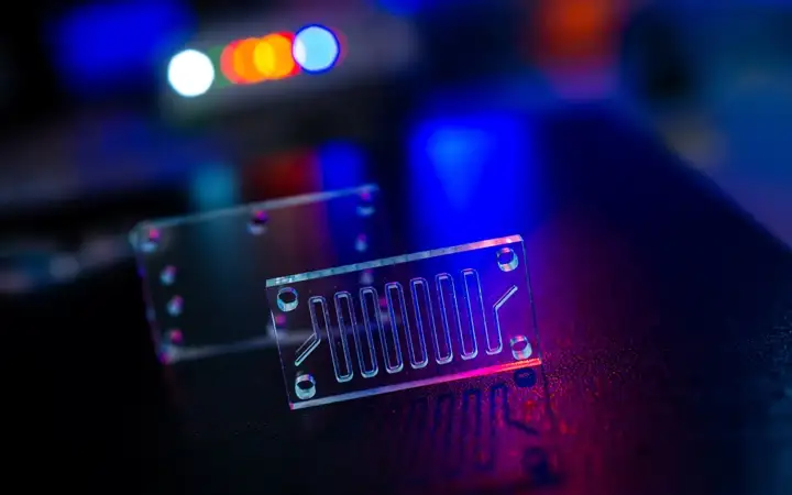 Micro-fluidic device Instrument on a laboratory table with a dark background