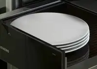 White plates inside a warming drawer