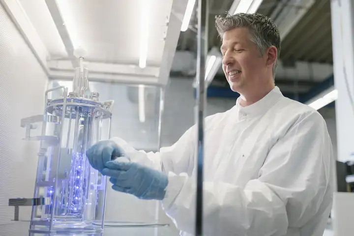 Scientist working at tabletop bioreactor