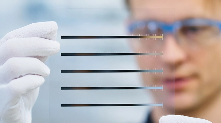 Expert inspecting glass wafer with conductive structures