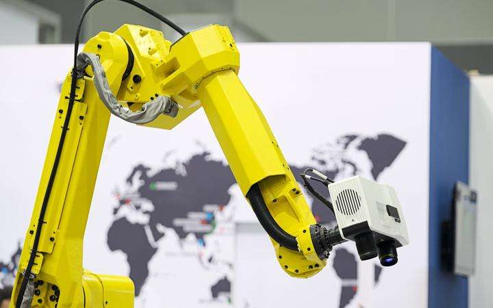 Yellow robot arm with camera attached