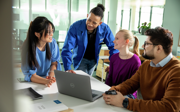 Group of young people talking in an office