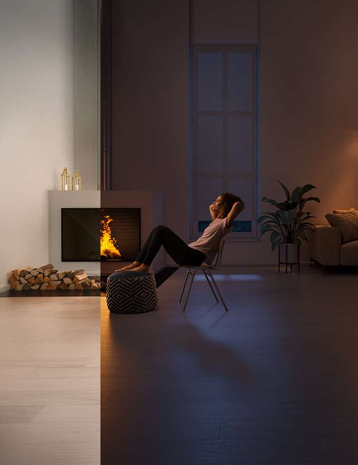Mujer relajándose frente a una chimenea de madera con el panel vitrocerámico ROBAX® NightFlame