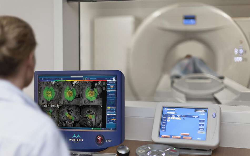 Medical technician in the control room of an MRI scanner