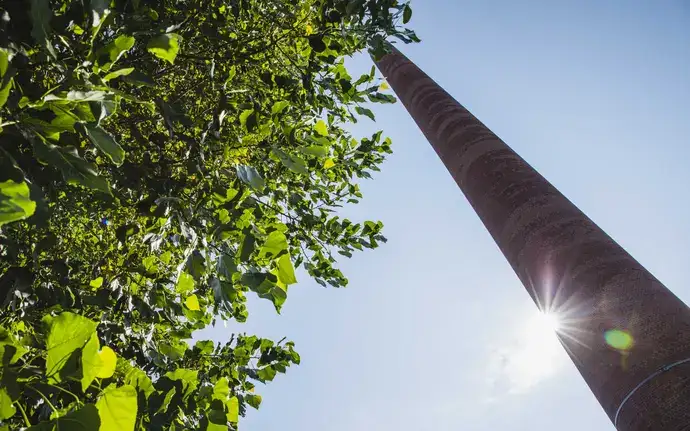 Close-up of the chimney of the SCHOTT plant in Mainz in the landscape