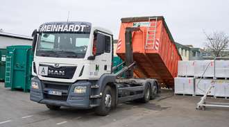 The orange container is pulled onto the truck on the sanofi premises	