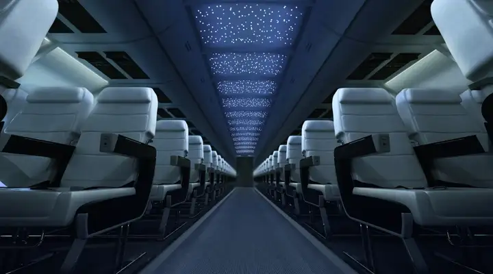 Interior of an aircraft at night lit up by the SCHOTT Star Ceiling aircraft cabin lighting system