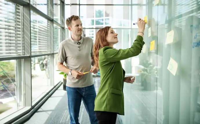 Frau schreibt an ein Whiteboard