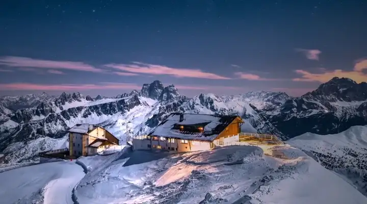 Mountain landscape at sunset with mountain lodge