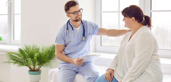 doctor comforting female patient in consulting room AdobeStock_624436500.jpeg