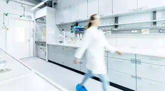Female technician walks across a laboratory