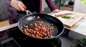 Hazelnuts are roasted in a pan