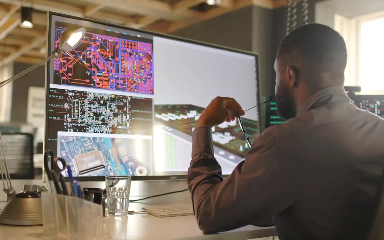 Cadelectrician watching at a screen