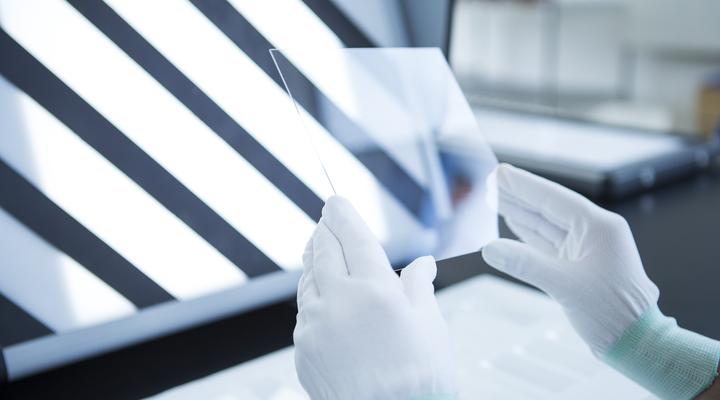 Scientist examining a piece of glass in the laboratory