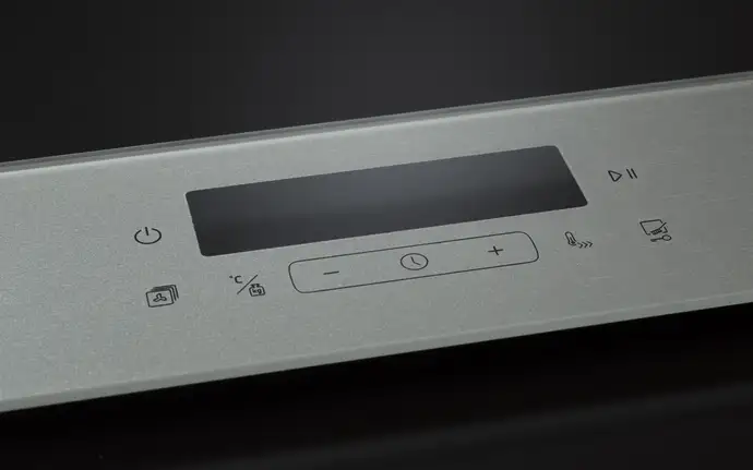 Control panel made of glass with brush craft print. Featuring power, temperature, and timer buttons, plus a central display screen and function icons including play/pause.