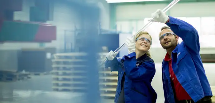 SCHOTT employees holding tubing glass