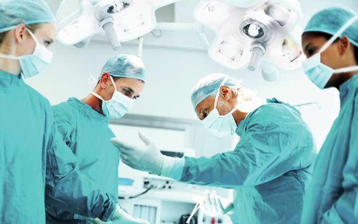 Four doctors in a hospital operating theater