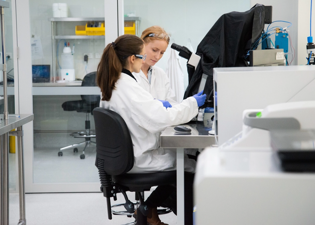 Two scientists examine a sample in a laboratory 