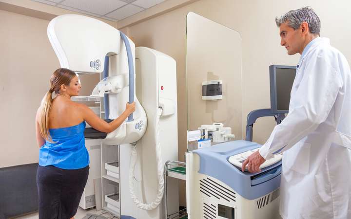Female patient undergoing a mammogram at the hospital