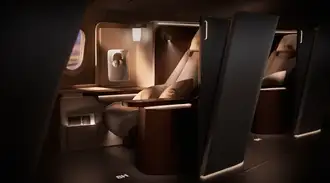 A passenger seat in an aircraft illuminated with seat lighting