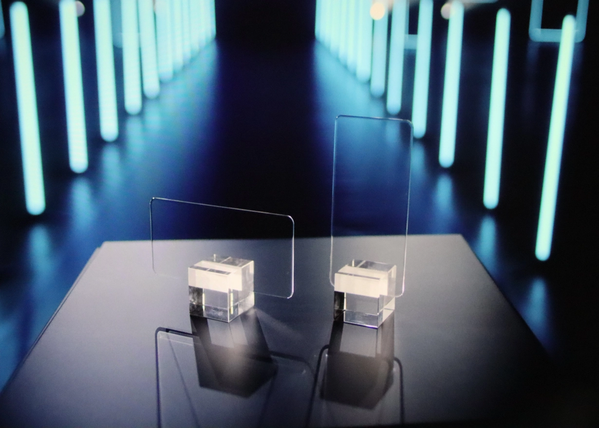 Two cover glass samples standing on a table.