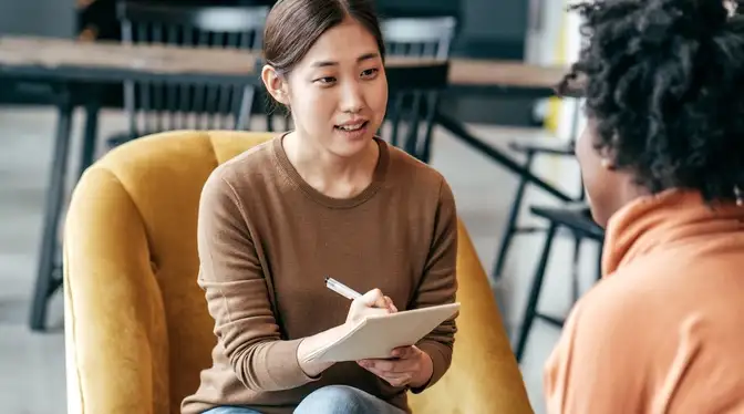 Two young people talking together