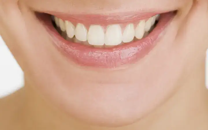 Close up of a female mouth smiling showing teeth
