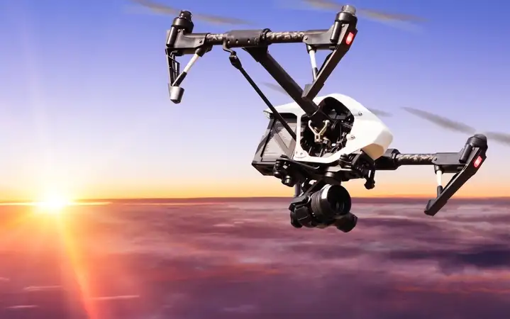 Four-rotor drone in the sky as the sun comes up