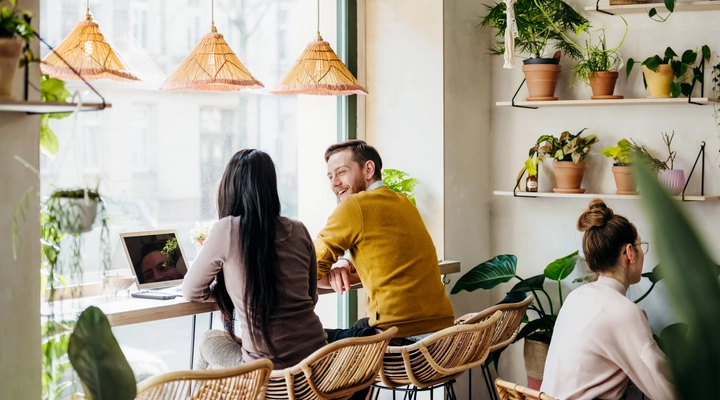 Two young people having a conversation in a cafe