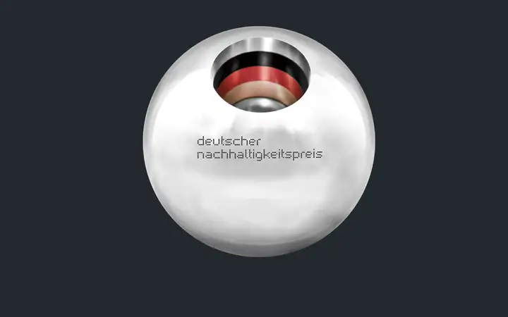 Close-up view of a silver ball with black-red-gold stripes in the middle and the text: German Sustainability Award