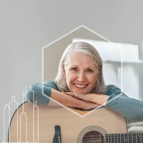 Middle-aged woman leaning on an acoustic guitar