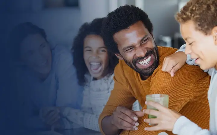 Three people sitting together and laughing